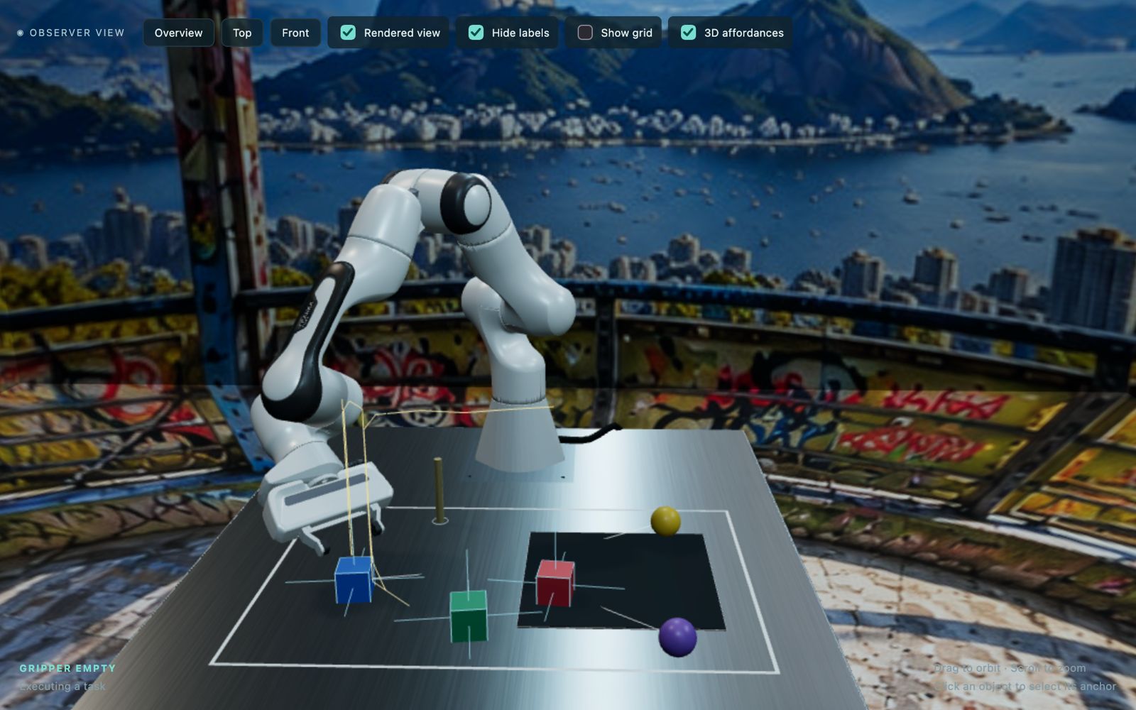 Vista frontal do Digital Twin MMSW: braço robótico Aster, cubos coloridos, esferas e marcadores de affordances no espaço de trabalho
